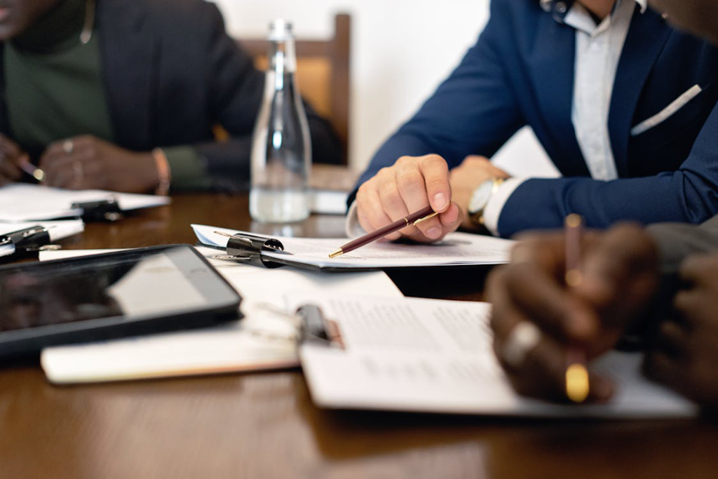 Business professionals reviewing a commercial sublease agreement at a meeting table