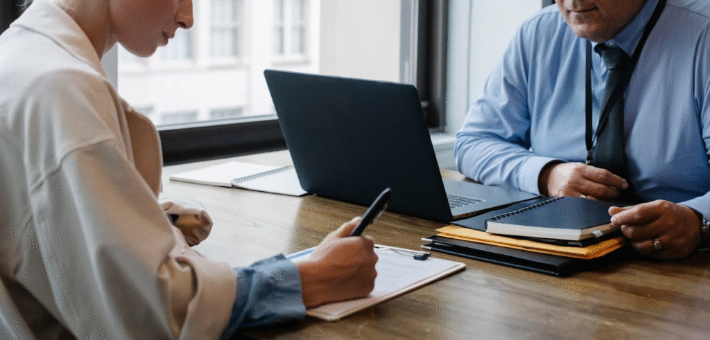 two people sitting at a desk.