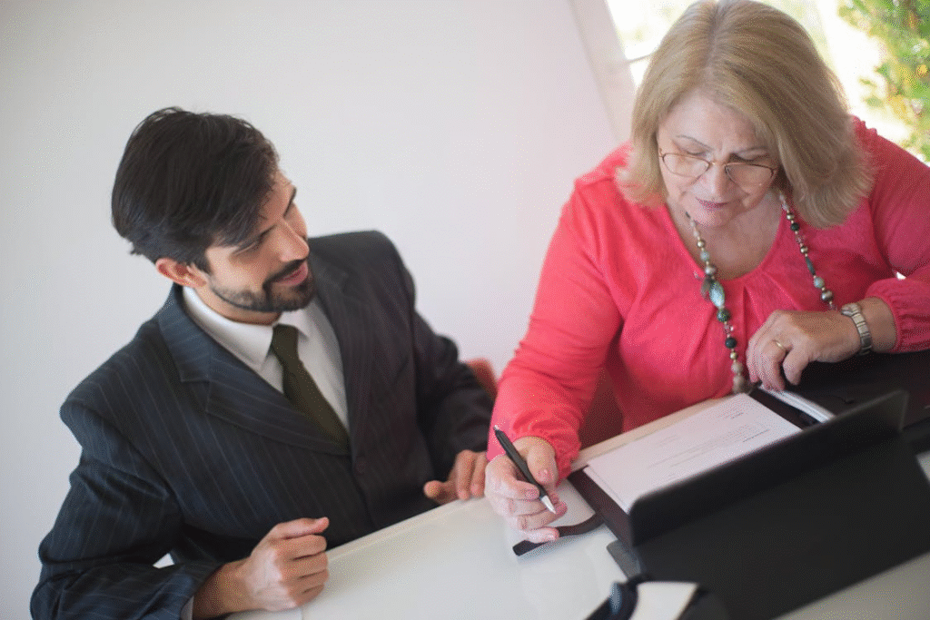 a woman in a red top signing a document.