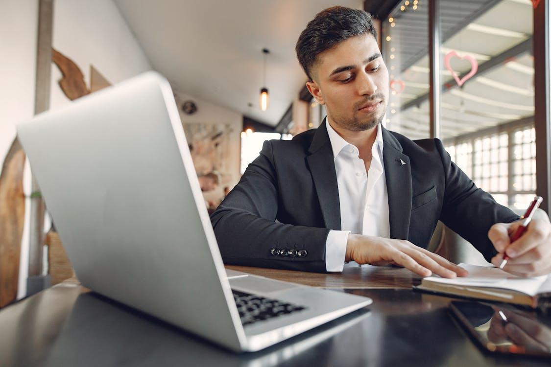 UK solicitor drafting a Non-Disclosure Agreement for a business client on a laptop
