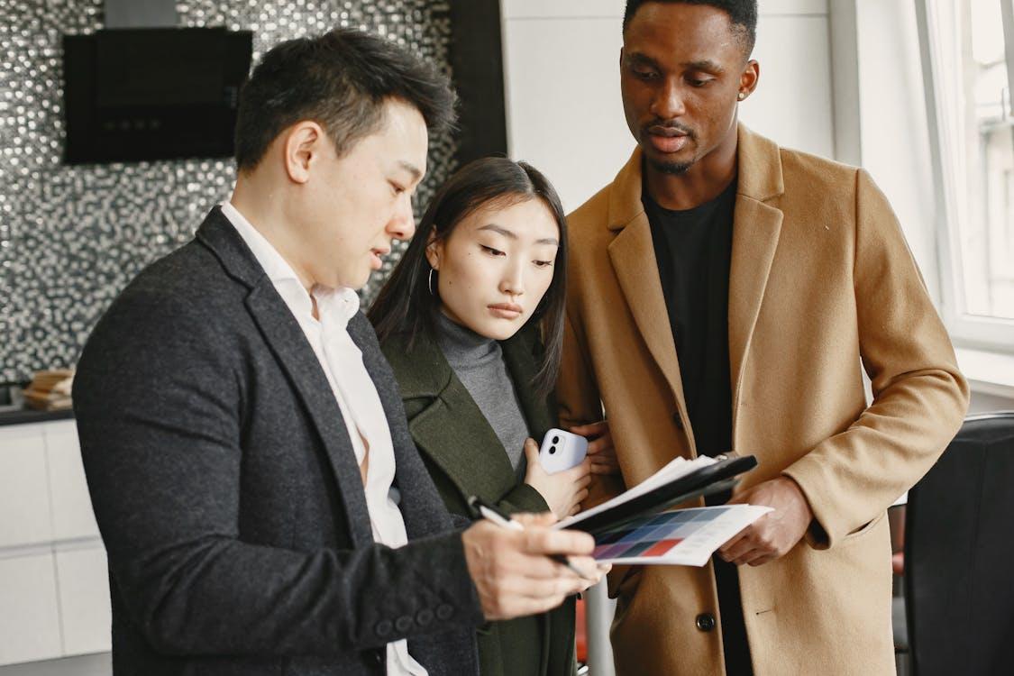 three people going over a document.