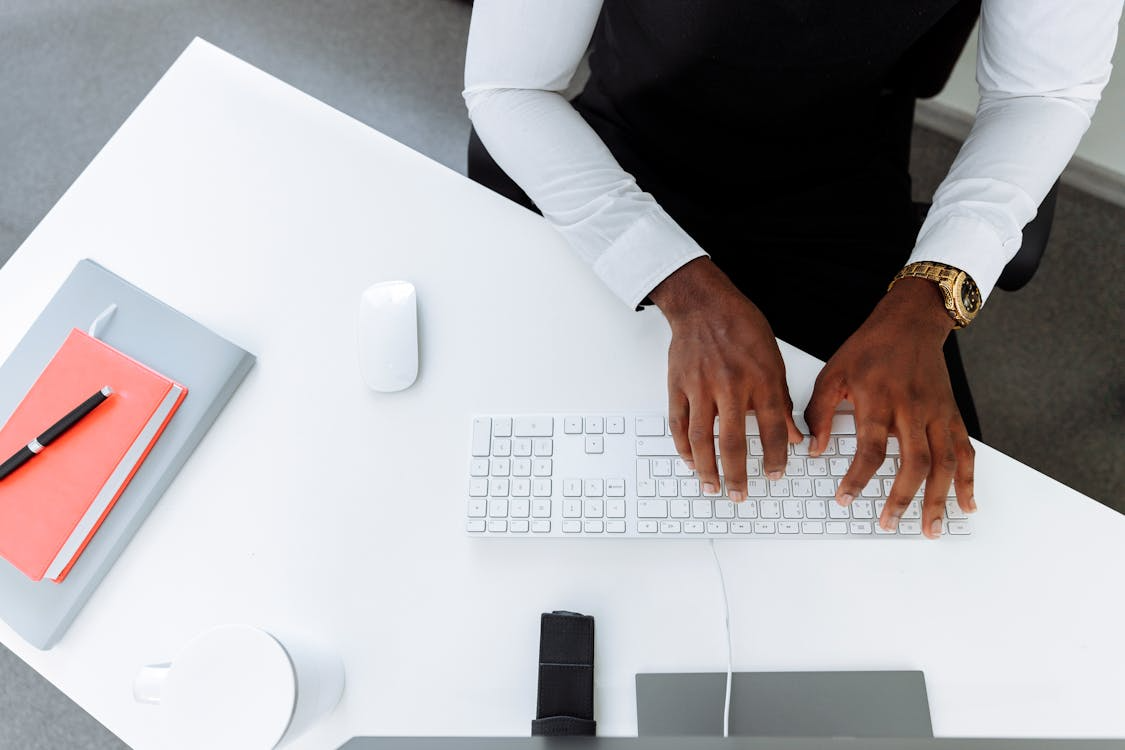 Business professional drafting a SaaS contract on a computer.